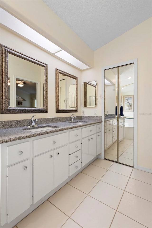 26901 Racquet Cir, Leesburg, FL 34748 - full bathroom with tile patterned flooring, double vanity, and a sink
