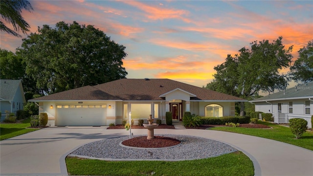 26901 Racquet Cir, Leesburg, FL 34748 - view of front of property featuring a front yard, a garage, stucco siding, and curved driveway