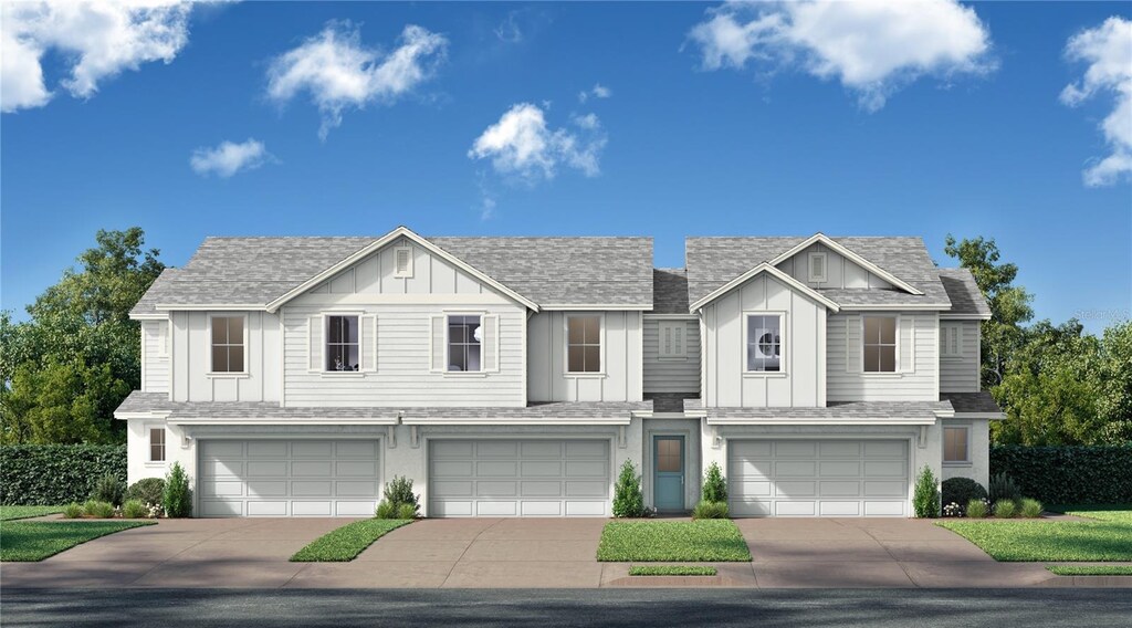 view of front of house featuring board and batten siding, driveway, a garage, and roof with shingles