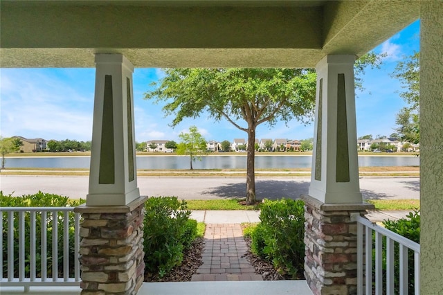 view of patio / terrace featuring a porch and a water view