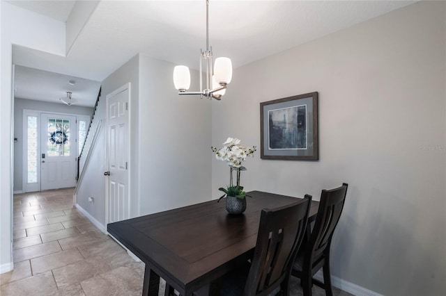 dining area with baseboards and a chandelier