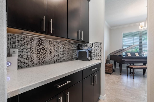 kitchen featuring crown molding, baseboards, and tasteful backsplash