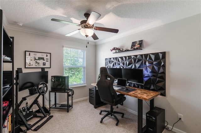 office area featuring ceiling fan, light colored carpet, a textured ceiling, baseboards, and ornamental molding