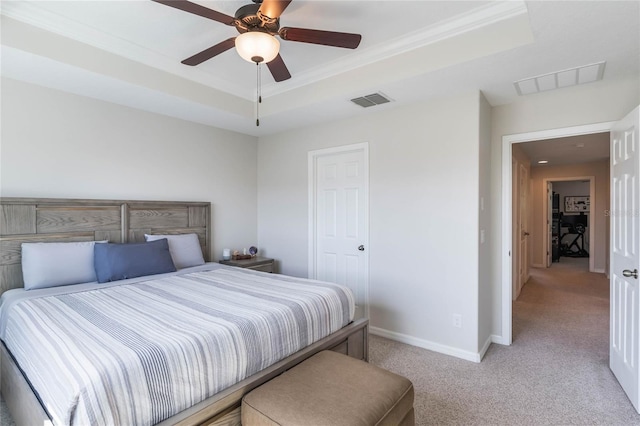 bedroom featuring visible vents, a raised ceiling, baseboards, and light colored carpet