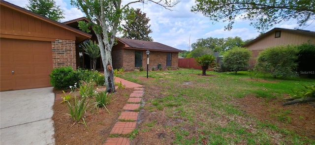 6277 Cranberry Ln W, Jacksonville, FL 32244 - view of yard featuring concrete driveway and an attached garage