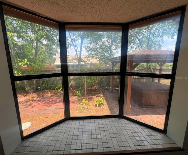 6277 Cranberry Ln W, Jacksonville, FL 32244 - unfurnished sunroom with tile patterned flooring, a jacuzzi, and healthy amount of natural light
