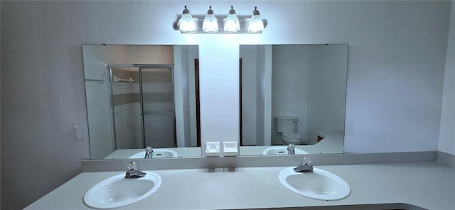 6277 Cranberry Ln W, Jacksonville, FL 32244 - bathroom featuring toilet, double vanity, and a shower with shower door