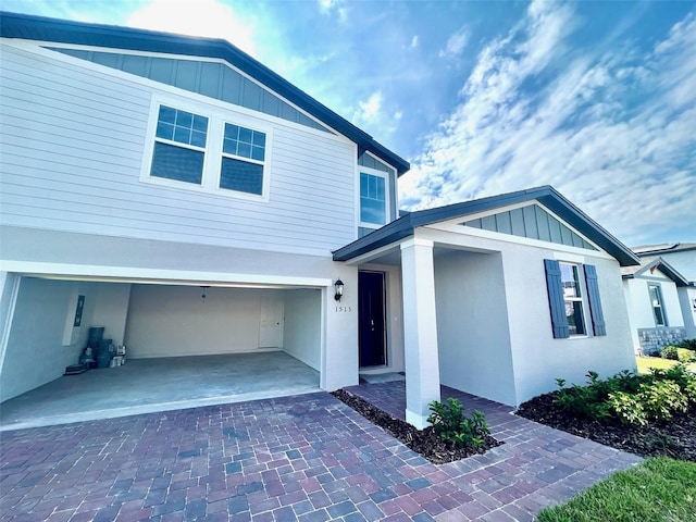 1513 Congaree St Unit 1513, Davenport, FL 33837 - view of front of house with a garage, board and batten siding, and decorative driveway
