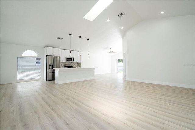 2218 Newt St, Orlando, FL 32837 - unfurnished living room with visible vents, a skylight, light wood finished floors, and recessed lighting
