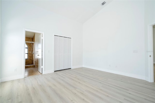 2218 Newt St, Orlando, FL 32837 - unfurnished bedroom featuring connected bathroom, visible vents, baseboards, wood finished floors, and high vaulted ceiling