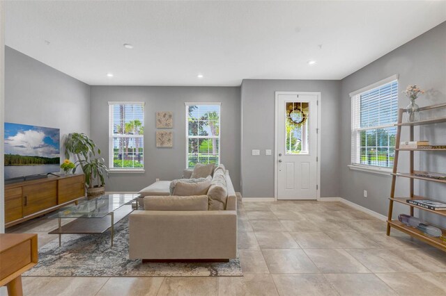 9433 Randal Park Blvd, Orlando, FL 32832 - living room featuring a healthy amount of sunlight, light tile patterned floors, baseboards, and recessed lighting