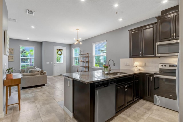 9433 Randal Park Blvd, Orlando, FL 32832 - kitchen featuring stone countertops, tasteful backsplash, visible vents, stainless steel appliances, and a sink
