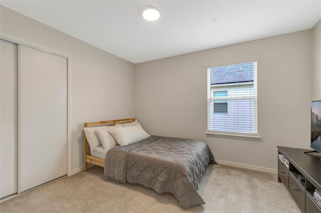 9433 Randal Park Blvd, Orlando, FL 32832 - bedroom with a closet, baseboards, and light carpet