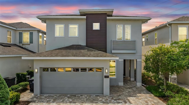 7759 Westland Dr, Kissimmee, FL 34747 - view of front facade with stucco siding, decorative driveway, and a garage