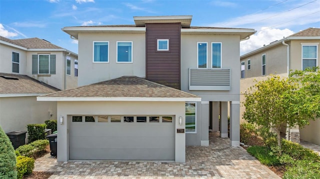7759 Westland Dr, Kissimmee, FL 34747 - view of front facade featuring driveway, stucco siding, and roof with shingles