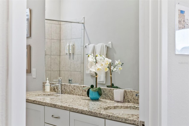 7759 Westland Dr, Kissimmee, FL 34747 - bathroom with double vanity, a shower stall, and a sink
