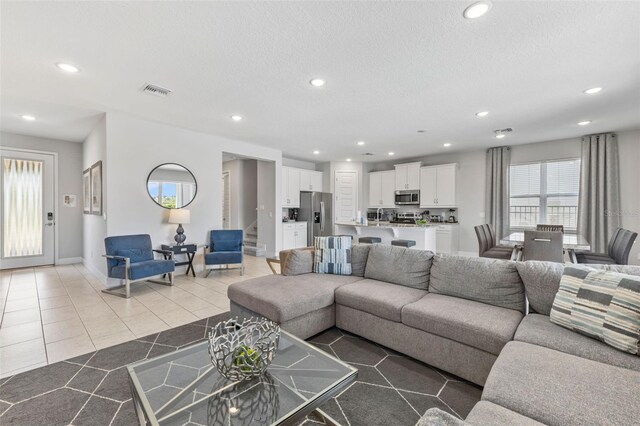 7759 Westland Dr, Kissimmee, FL 34747 - living room with baseboards, visible vents, recessed lighting, and light tile patterned floors