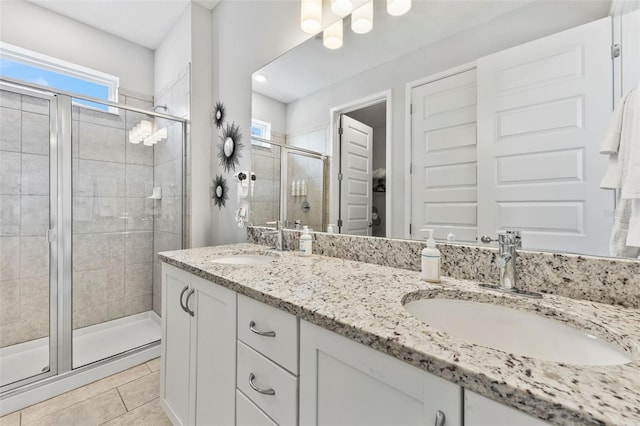 7759 Westland Dr, Kissimmee, FL 34747 - bathroom with tile patterned floors, a sink, a shower stall, and double vanity