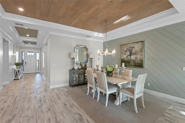 dining room with an inviting chandelier, light wood-style flooring, baseboards, visible vents, and ornamental molding
