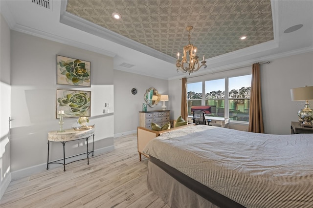 bedroom with crown molding, a chandelier, wood finished floors, a tray ceiling, and visible vents