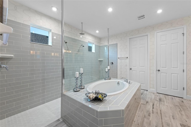 full bathroom with walk in shower, recessed lighting, a bath, and wood finished floors