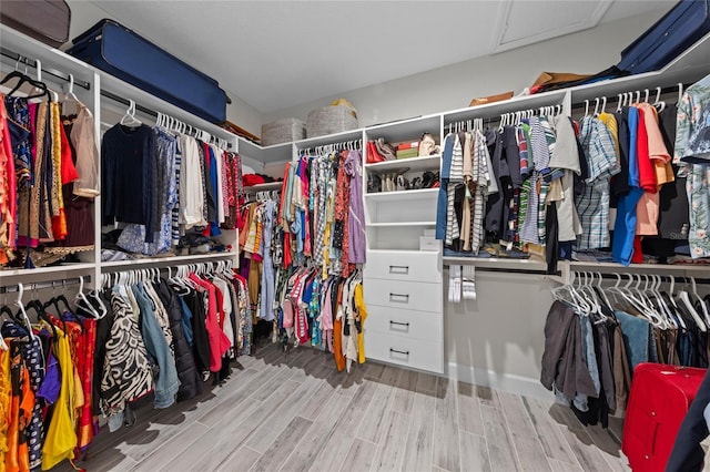 walk in closet featuring attic access and wood tiled floor