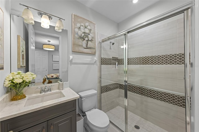 bathroom with vanity, a shower stall, toilet, and ensuite bath