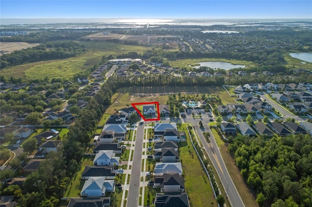 drone / aerial view with a residential view and a water view
