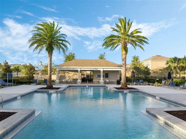 pool featuring a patio and fence
