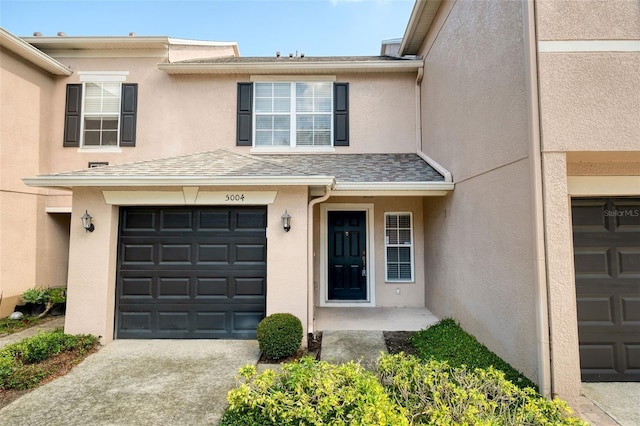 5004 Ashford Falls Ln, Oviedo, FL 32765 - property entrance featuring stucco siding, concrete driveway, and a garage