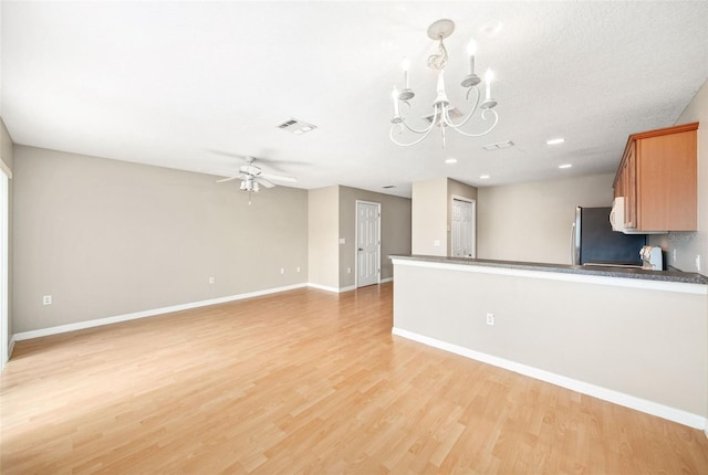 5004 Ashford Falls Ln, Oviedo, FL 32765 - kitchen featuring refrigerator, a chandelier, light wood finished floors, baseboards, and ceiling fan