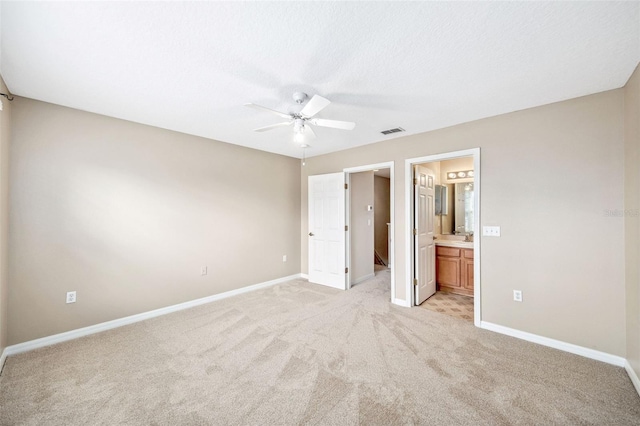 5004 Ashford Falls Ln, Oviedo, FL 32765 - unfurnished bedroom featuring light carpet, baseboards, connected bathroom, a ceiling fan, and a sink