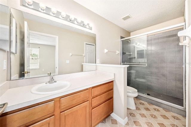 5004 Ashford Falls Ln, Oviedo, FL 32765 - bathroom featuring toilet, a shower stall, vanity, tile patterned flooring, and a textured ceiling