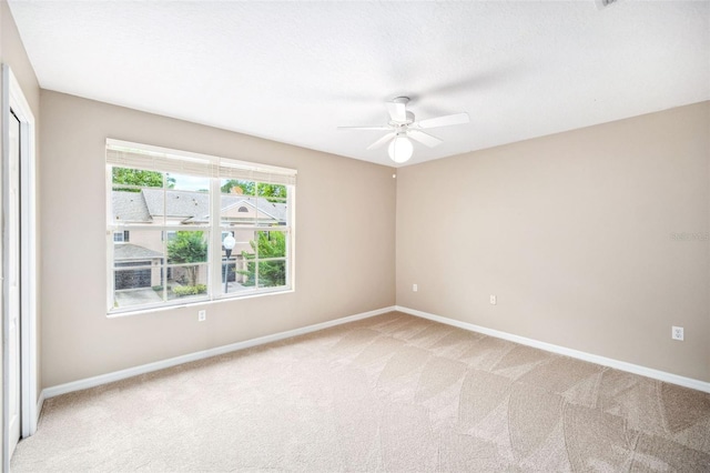 5004 Ashford Falls Ln, Oviedo, FL 32765 - unfurnished room with light carpet, baseboards, and ceiling fan