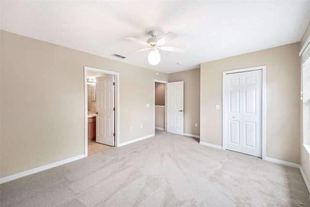 5004 Ashford Falls Ln, Oviedo, FL 32765 - unfurnished bedroom featuring light carpet, baseboards, connected bathroom, and ceiling fan