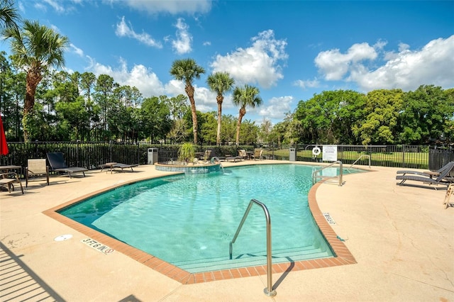 5004 Ashford Falls Ln, Oviedo, FL 32765 - community pool featuring a patio, fence, and view of scattered trees