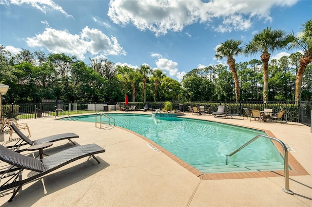 5004 Ashford Falls Ln, Oviedo, FL 32765 - community pool featuring a patio, view of wooded area, and fence