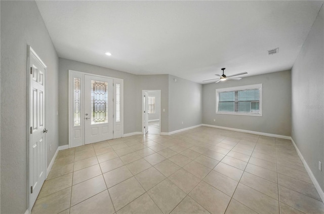 5829 Valentino Way, Lakeland, FL 33812 - foyer featuring baseboards, light tile patterned flooring, ceiling fan, and a wealth of natural light