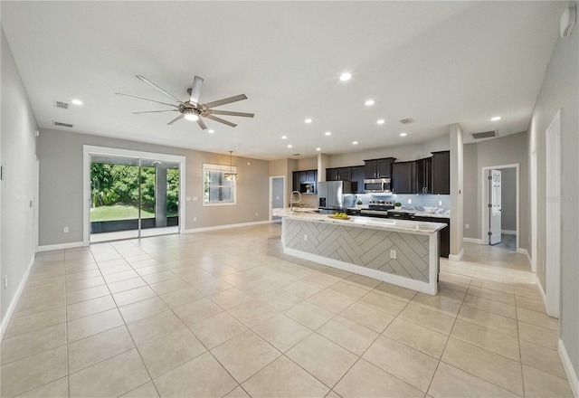 5829 Valentino Way, Lakeland, FL 33812 - kitchen featuring visible vents, open floor plan, ceiling fan, a spacious island, and stainless steel appliances