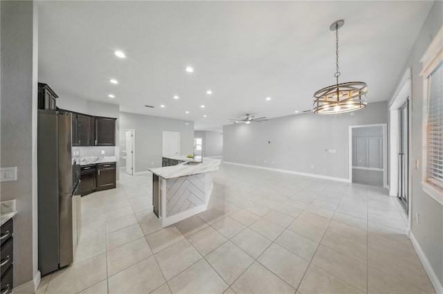 5829 Valentino Way, Lakeland, FL 33812 - kitchen with light tile patterned floors, baseboards, freestanding refrigerator, ceiling fan with notable chandelier, and recessed lighting