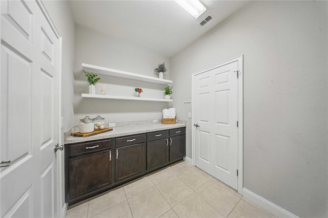 5829 Valentino Way, Lakeland, FL 33812 - bar with visible vents, baseboards, and light tile patterned floors