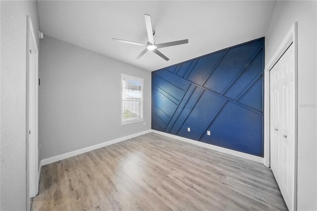5829 Valentino Way, Lakeland, FL 33812 - unfurnished bedroom featuring baseboards, a ceiling fan, wood finished floors, and a closet