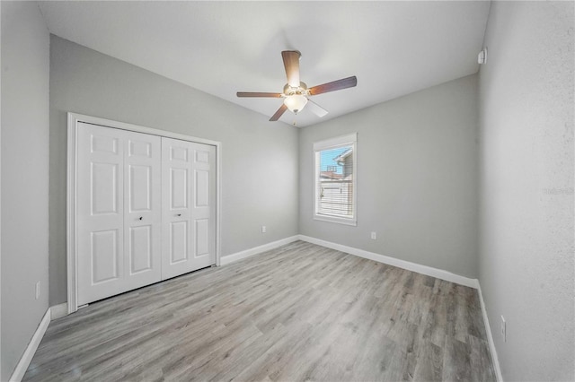 5829 Valentino Way, Lakeland, FL 33812 - unfurnished bedroom featuring baseboards, ceiling fan, wood finished floors, and a closet