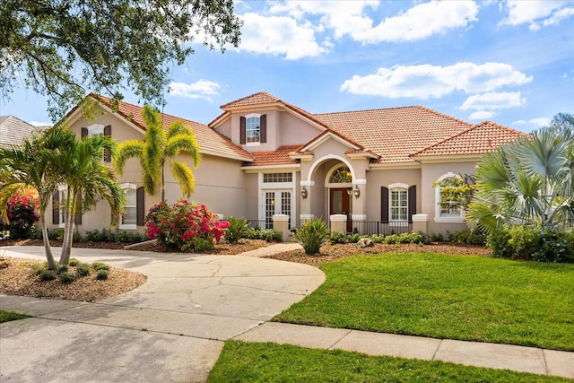 10664 Emerald Chase Dr, Orlando, FL 32836 - mediterranean / spanish house with a front yard, stucco siding, curved driveway, and a tile roof