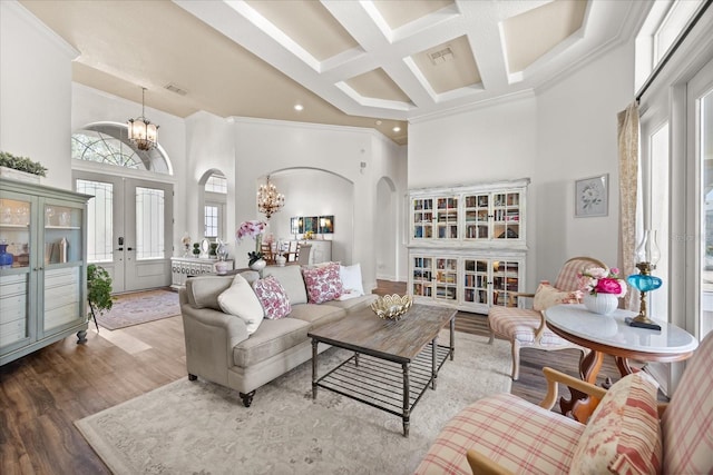 10664 Emerald Chase Dr, Orlando, FL 32836 - living area with arched walkways, a notable chandelier, a high ceiling, and coffered ceiling