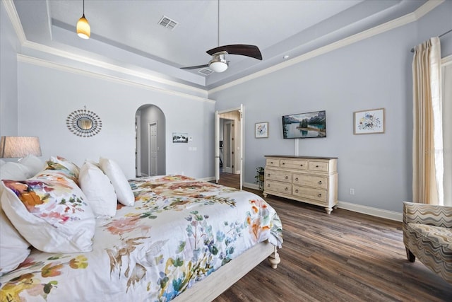 10664 Emerald Chase Dr, Orlando, FL 32836 - bedroom with a raised ceiling, arched walkways, crown molding, and dark wood finished floors