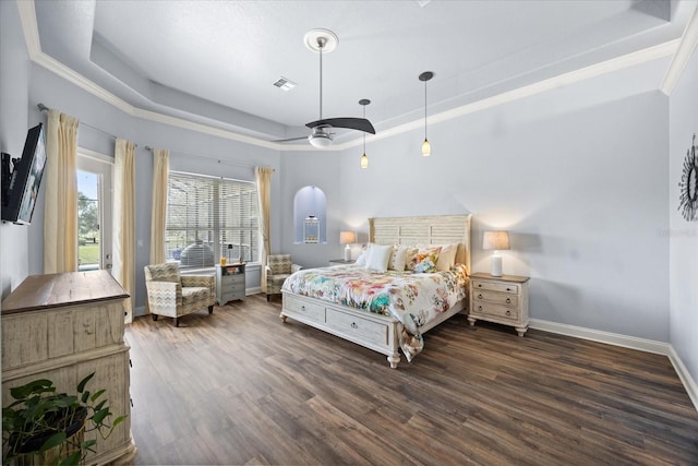 10664 Emerald Chase Dr, Orlando, FL 32836 - bedroom featuring baseboards, crown molding, visible vents, a tray ceiling, and wood finished floors