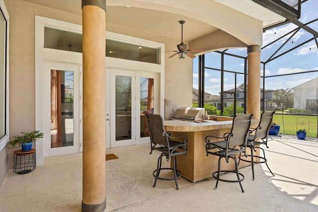 10664 Emerald Chase Dr, Orlando, FL 32836 - view of patio / terrace with area for grilling, a ceiling fan, outdoor wet bar, and glass enclosure