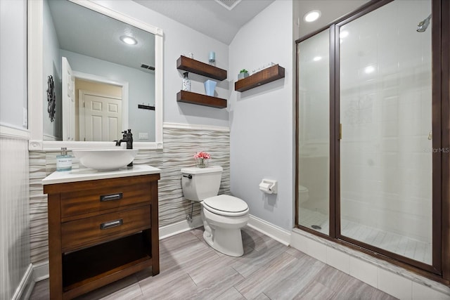 10664 Emerald Chase Dr, Orlando, FL 32836 - full bath featuring visible vents, toilet, a shower stall, vanity, and wainscoting