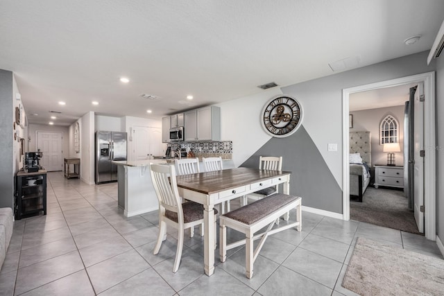 dining room featuring light tile patterned floors, recessed lighting, beverage cooler, and visible vents